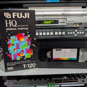 Fuji HQ T-120 sleeve beside a black BASF VHS labeled Pasquale’s Kitchen.