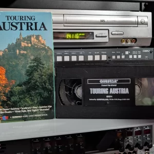 Questar Touring Austria illustrated sleeve beside its printed Travel the World VHS.
