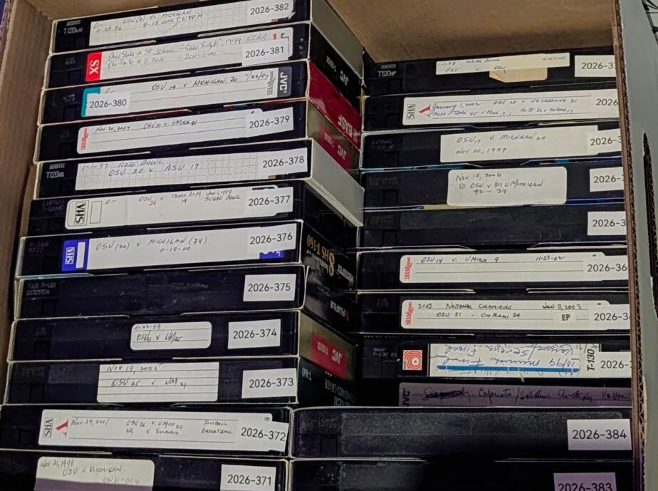 Cardboard box packed with labeled VHS tapes set aside for a collector