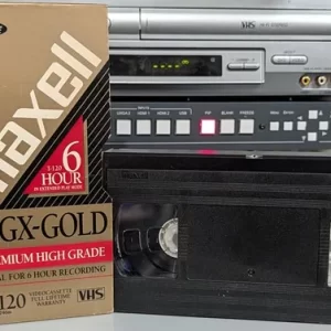 Unlabeled Maxell VHS beside its HGX-Gold T-120 sleeve.