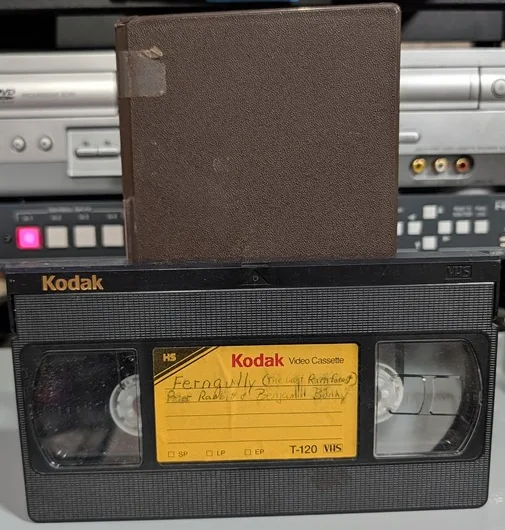 Kodak VHS with handwritten program label and brown sleeve.