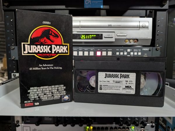 MCA Universal clamshell with red logo and dinosaur skeleton, Jurassic Park, 1993 Spielberg film on home video (VHS-2026-459)
