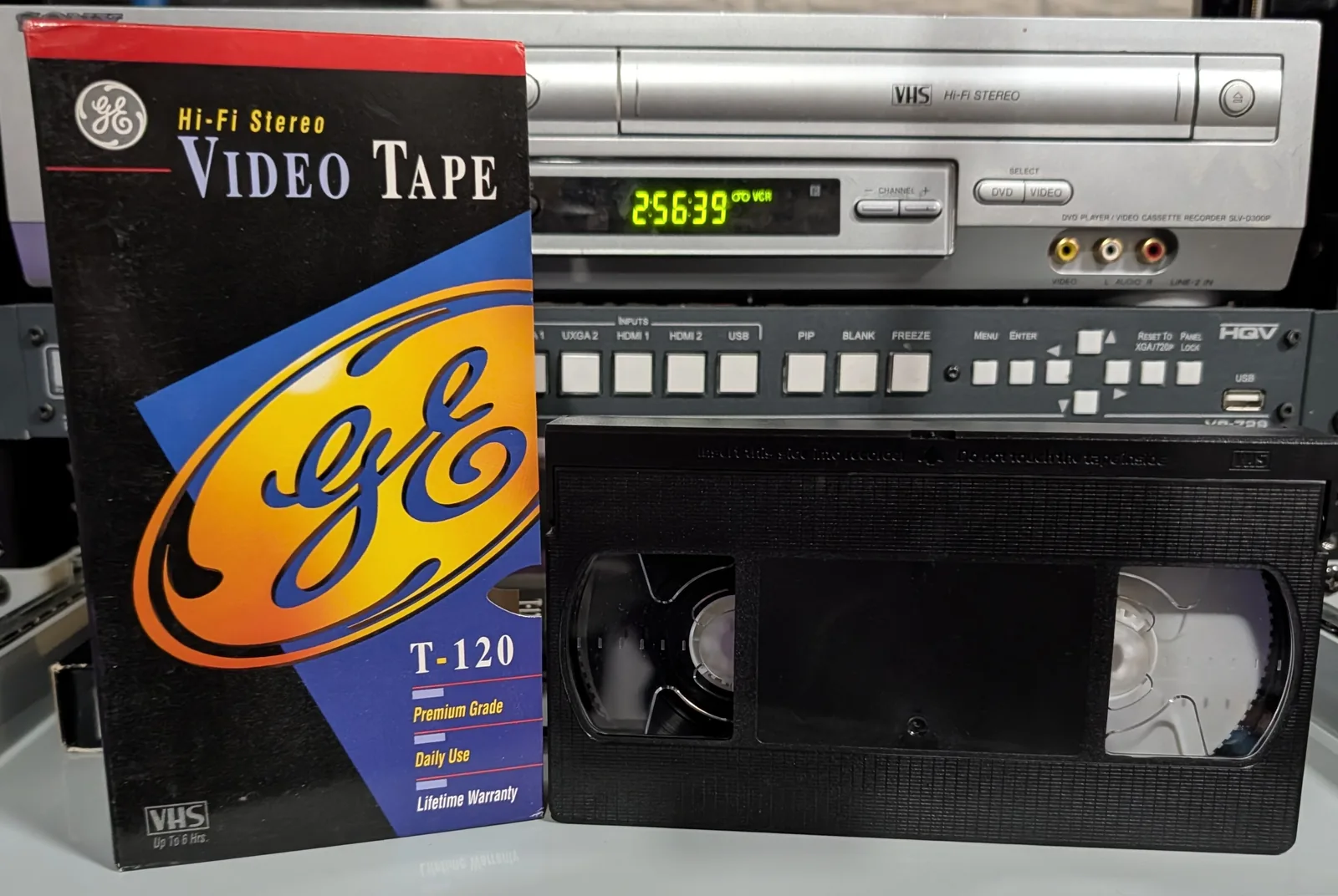 GE VHS tape beside its Premium Grade sleeve.
