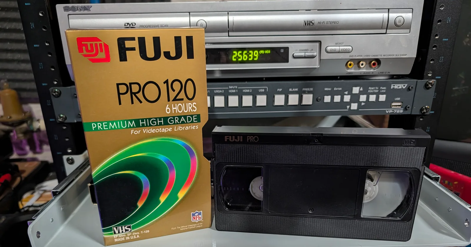 Full Fuji Pro 120 VHS tape beside its gold 6 Hours sleeve.