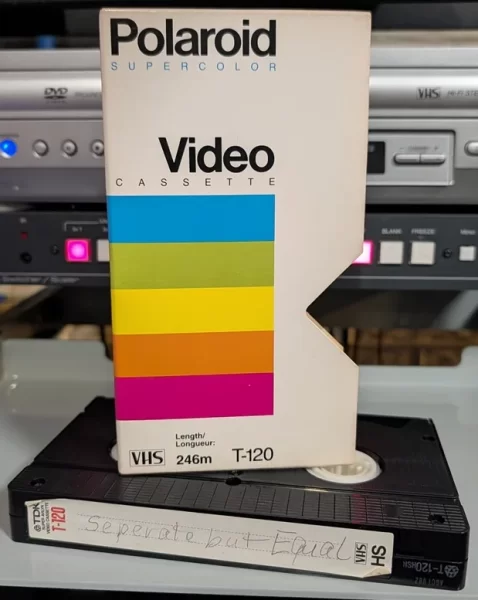Polaroid Supercolor sleeve above a TDK tape with a handwritten Separate but Equal label.
