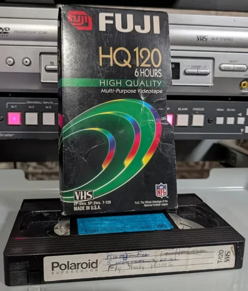 Polaroid VHS tape with worn Fuji sleeve and crossed-out handwritten label